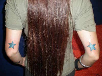Blue girl star tattoo on arm