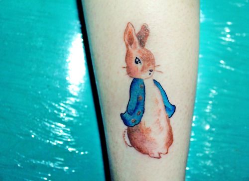 Blue jacket and lovely rabbit tattoo on arm