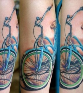 Blue lovely bicycle tattoo on arm