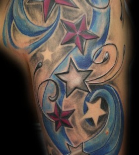 Blue ornaments and star tattoo on shoulder
