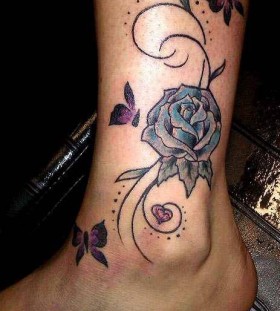 Blue rose and butterfly tattoo on leg