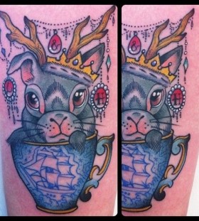 Blue ship, cup and rabbit tattoo on arm
