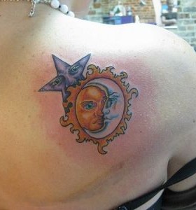 Blue star, yellow sun and white moon tattoo on shoulder