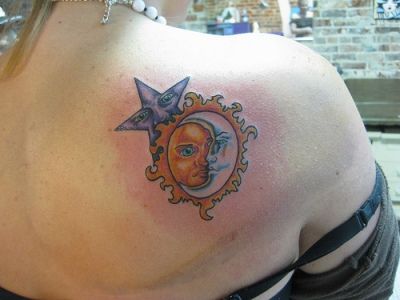 Blue star, yellow sun and white moon tattoo on shoulder
