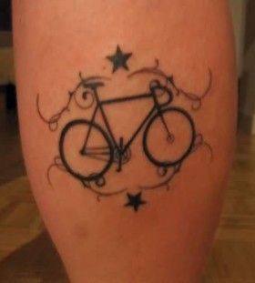 Blue stars and black bicycle tattoo on leg