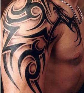 Bracelet and awesome tribal tattoo on arm