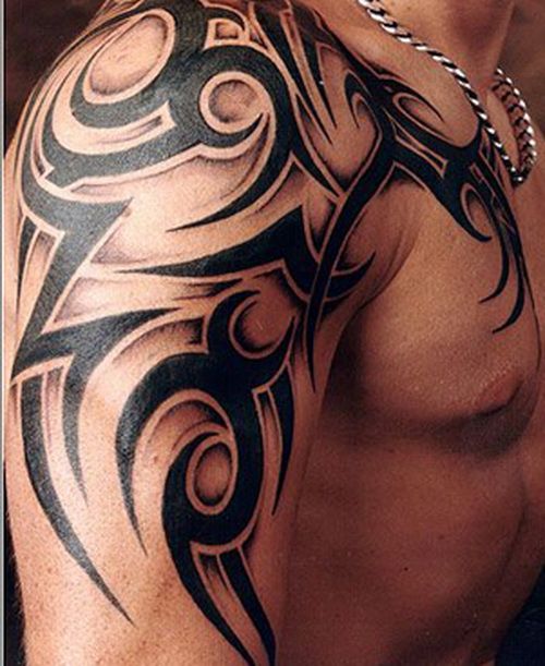 Bracelet and awesome tribal tattoo on arm
