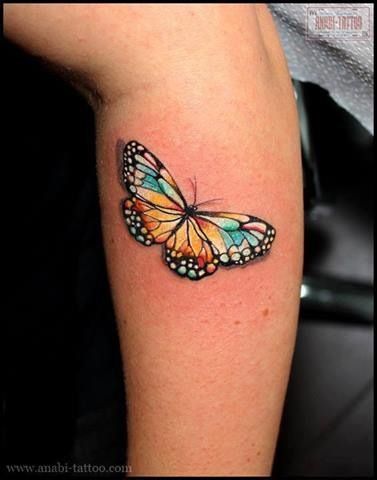 Bright simple butterfly tattoo on arm
