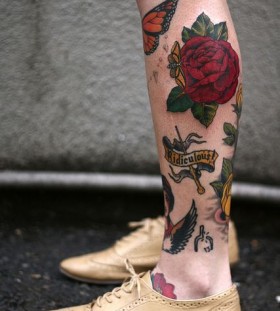 Butterflies and red rose tattoo on leg