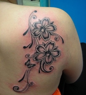 Butterfly and flowers tribal tattoo on shoulder