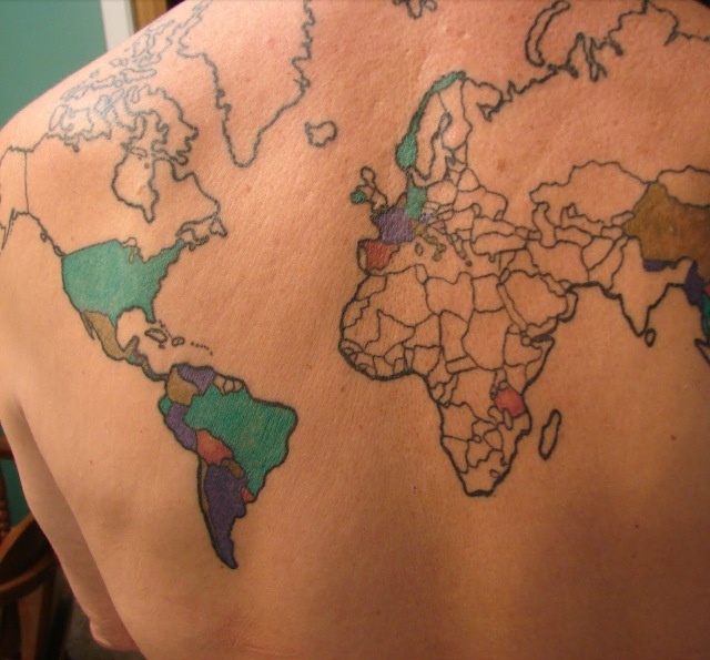 Colorful and black map tattoo on back
