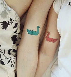 Colorful ducks origami tattoo on arm