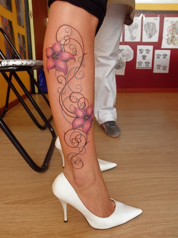 Colorful flower tattoo on leg