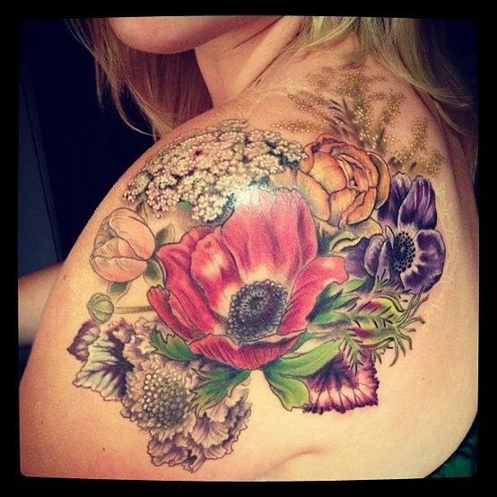 Colorful flowers and poppy tattoo on arm