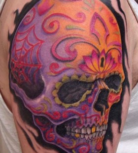 Colorful men's skull tattoo on shoulder