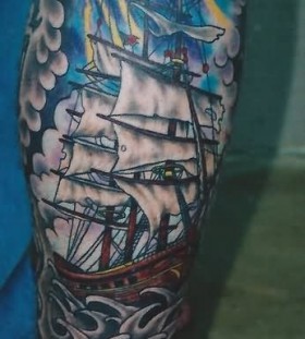 Colorful pirate ship tattoo on leg