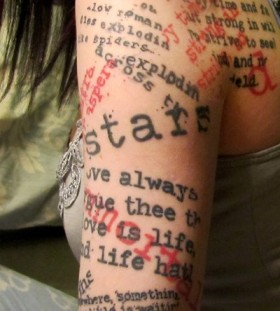 Colorful red and black quote tattoo on leg