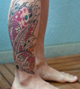 Colorful red fish tattoo on leg