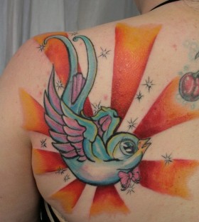 Colorful sun and bird tattoo on shoulder