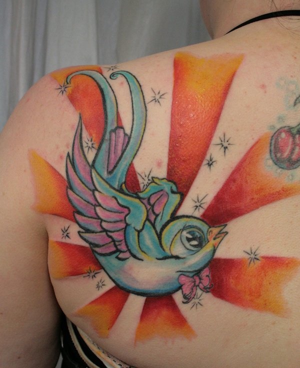 Colorful sun and bird tattoo on shoulder