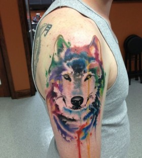 Colorful watercolor wolf tattoo on arm