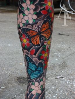 Colorful women butterfly tattoo on leg