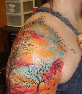 Colorful women's tree tattoo on shoulder