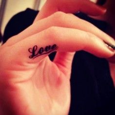 Creative black quote tattoo on finger