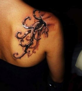 Cruel black tree tattoo on shoulder