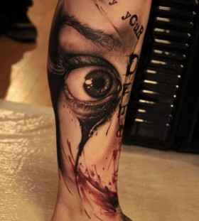 Cruel men's eye tattoo on leg