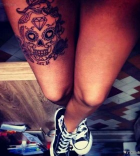 Crystal and skull tattoo on leg
