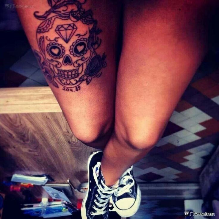 Crystal and skull tattoo on leg