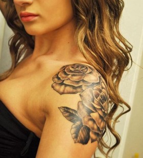 Curly hair girl rose tattoo on shoulder