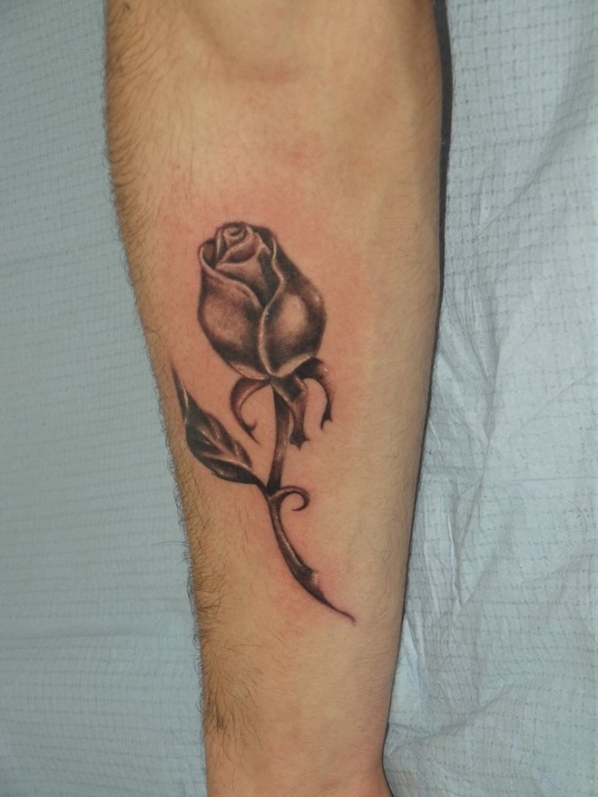 Cute black rose tattoo on arm