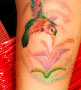 Cute colorful bird tattoo on leg