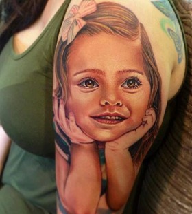 Cute girl face tattoo on arm