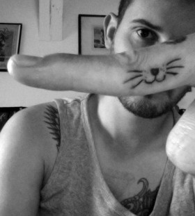 Cute mn's cat tattoo on finger
