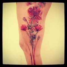 Cute red poppy tattoo on leg