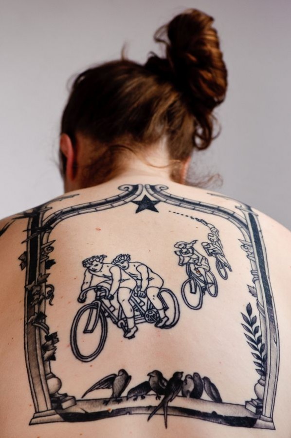 Cute women’s bicycle tattoo on back