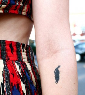 Dancing black rabbit tattoo on arm