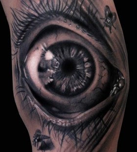 Eye and insect's ornaments tattoo