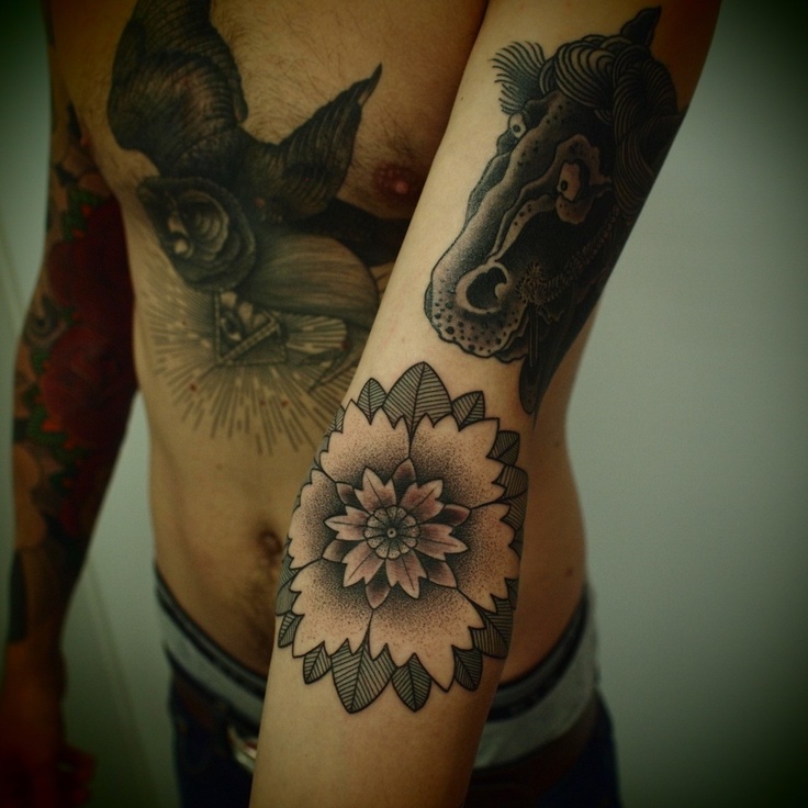 FLower and black horse tattoo on arm