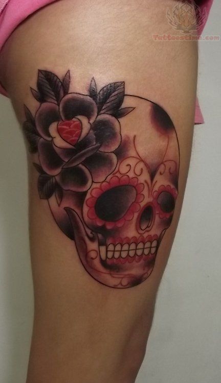 Flower and red skull tattoo on leg