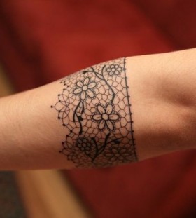 Flowers and lace line tattoo on arm