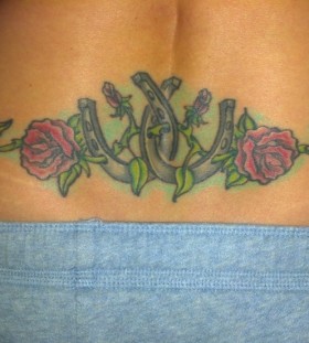 Flowers and lovely horse shoe tattoo