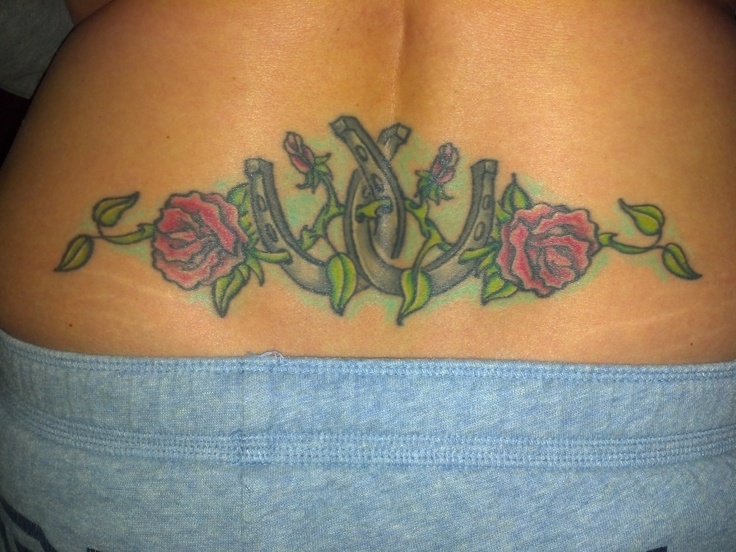Flowers and lovely horse shoe tattoo