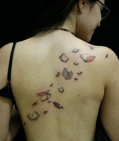 Flying colorful back book tattoo