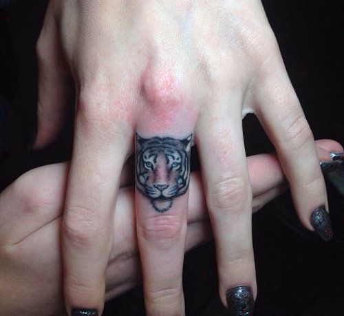 Funny tiger tattoo on finger