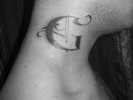G letter tattoo on neck