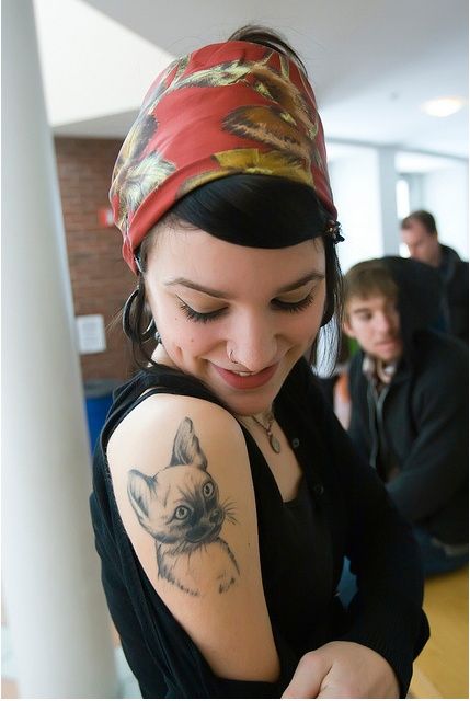 Girl lovely cat tattoo on arm